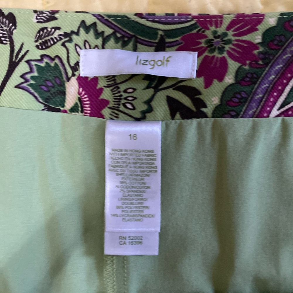 Skirt by Liz golf. Green and magenta pleat front and back. Size 16